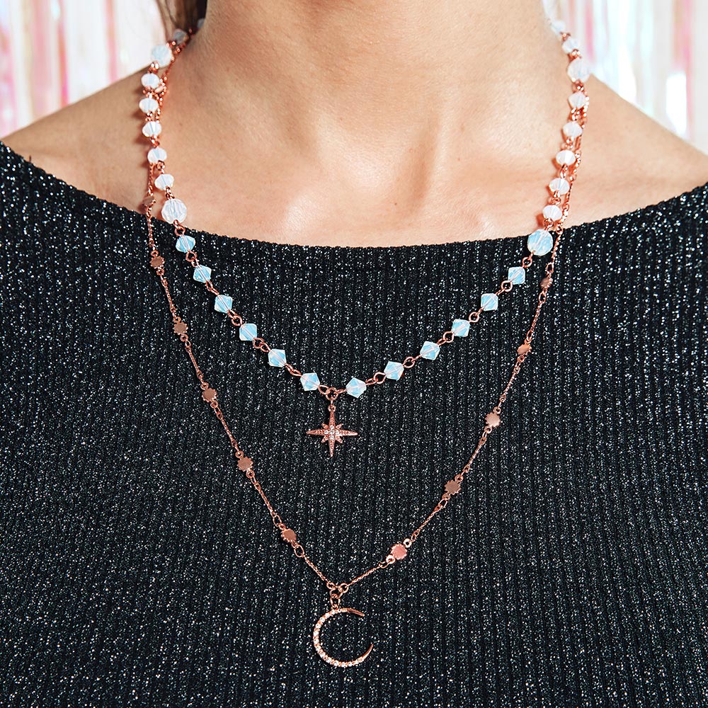 Callista moon and star layered necklace worn at the front with black dress