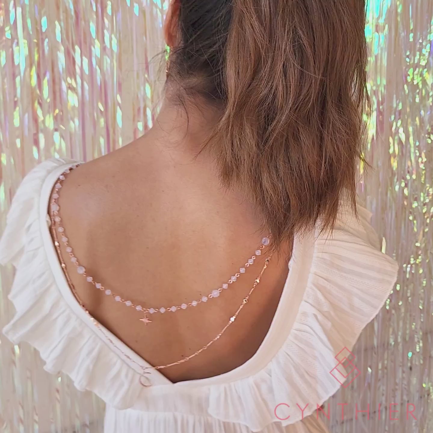 Callista Moon And Star Layered Necklace worn at the back with a white low back dress